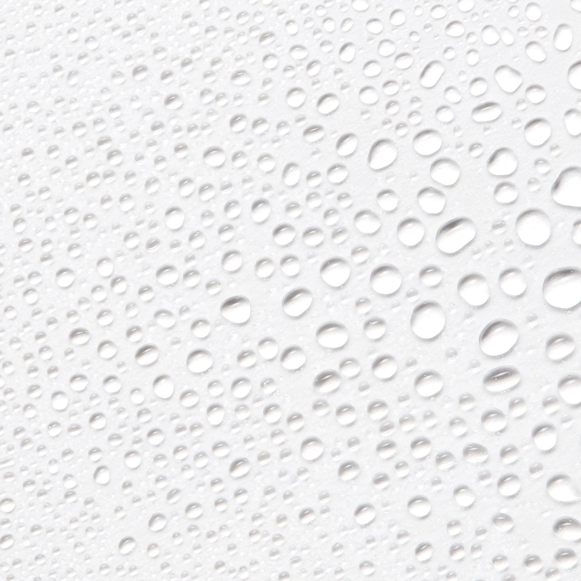 Close-up image of droplets from Antu Radiance Mist on a white background.