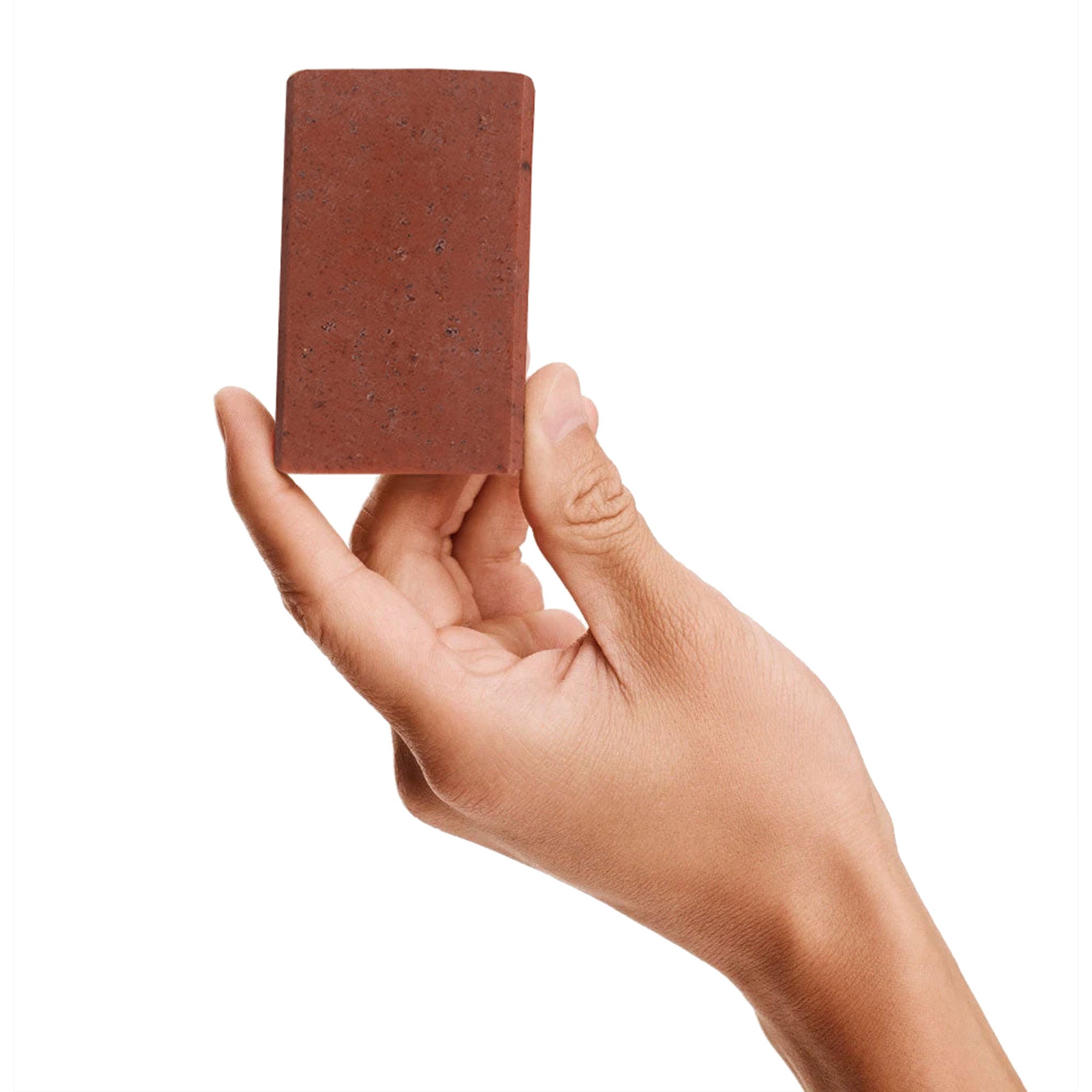 Image of a model holding a bar of Antü Restoring Soap.