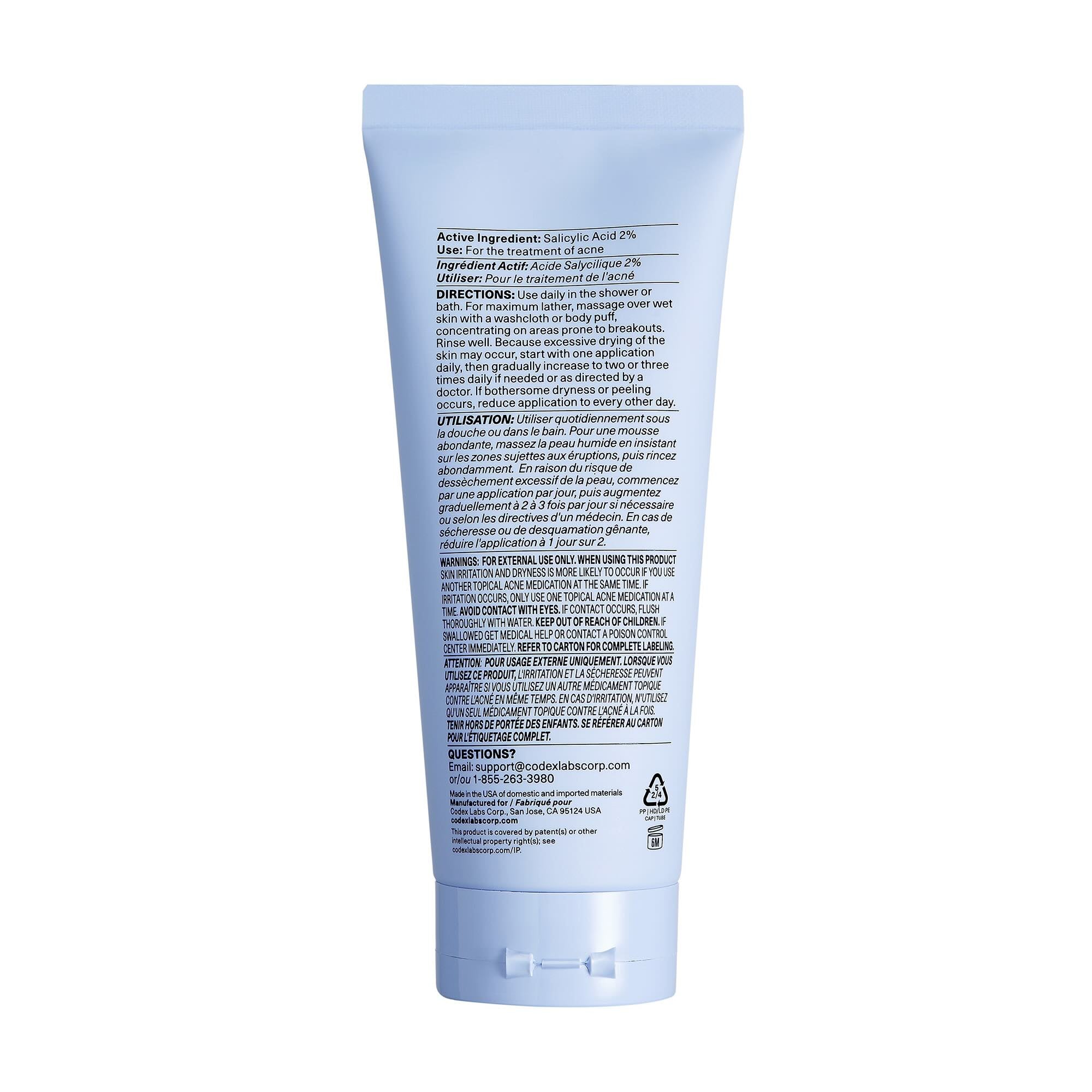 Shaant Hydrating Acne Body Scrub back of tube on white background.