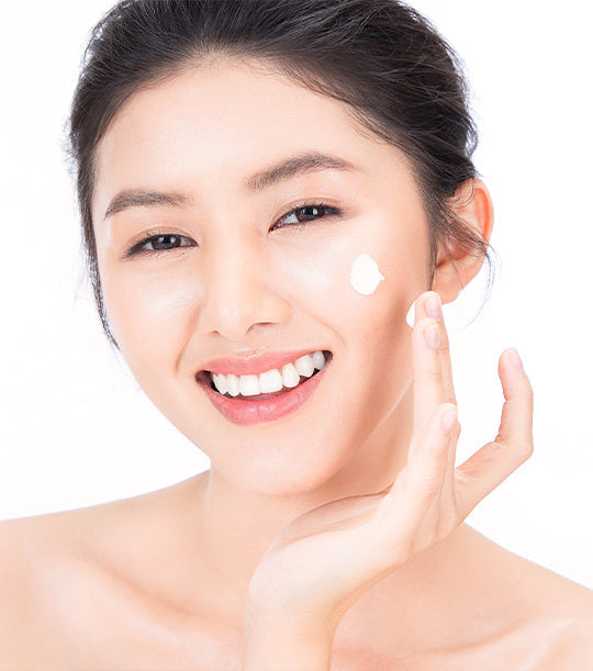 Image of a female model placing Antu Brightening Night Cream on her cheek.